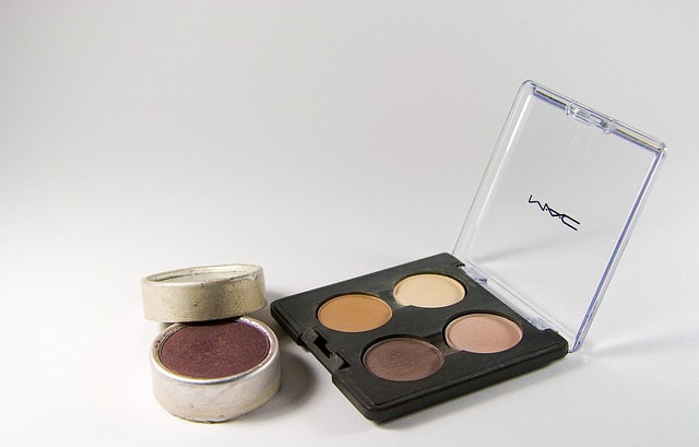 Palette of MAC cosmetics featuring four shades, alongside a single pot of deep burgundy pigment, relevant for eyebrow tinting and microblading color selection.