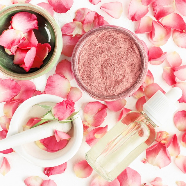 Rose petals surrounding natural skincare products, including a mortar and pestle, a glass dropper bottle, and a container of powder, emphasizing effective skincare routines and holistic beauty practices.